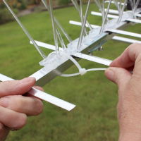 Defender® TV Aerial Pigeon Spikes being held in place with cable ties on a TV aerial 