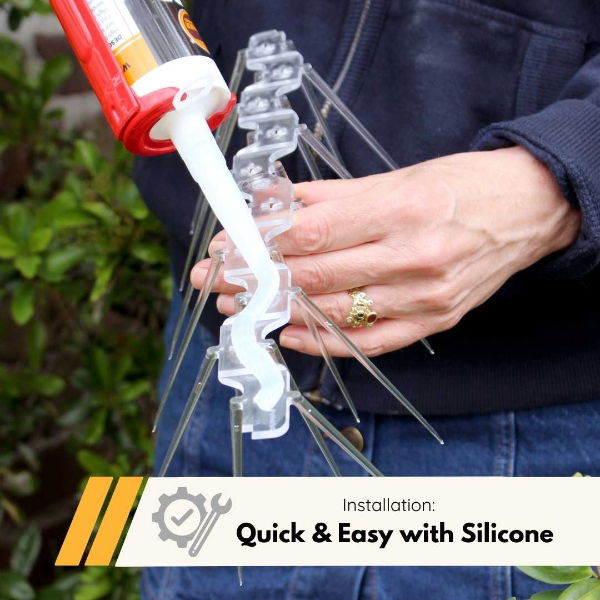 A person applying silicone adhesive to the base of Defender wide plastic bird spikes, ensuring a firm and long-lasting fix to any surface.