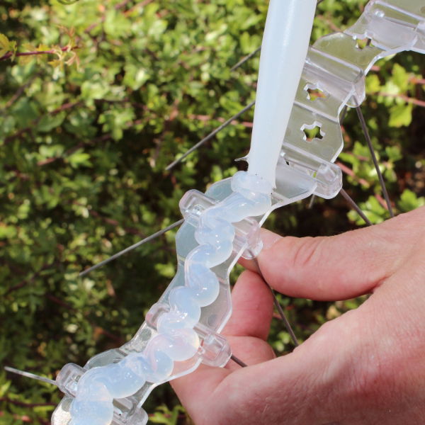 Defender® Fixing silicone being applied to the base of a gull spike ready for installation 